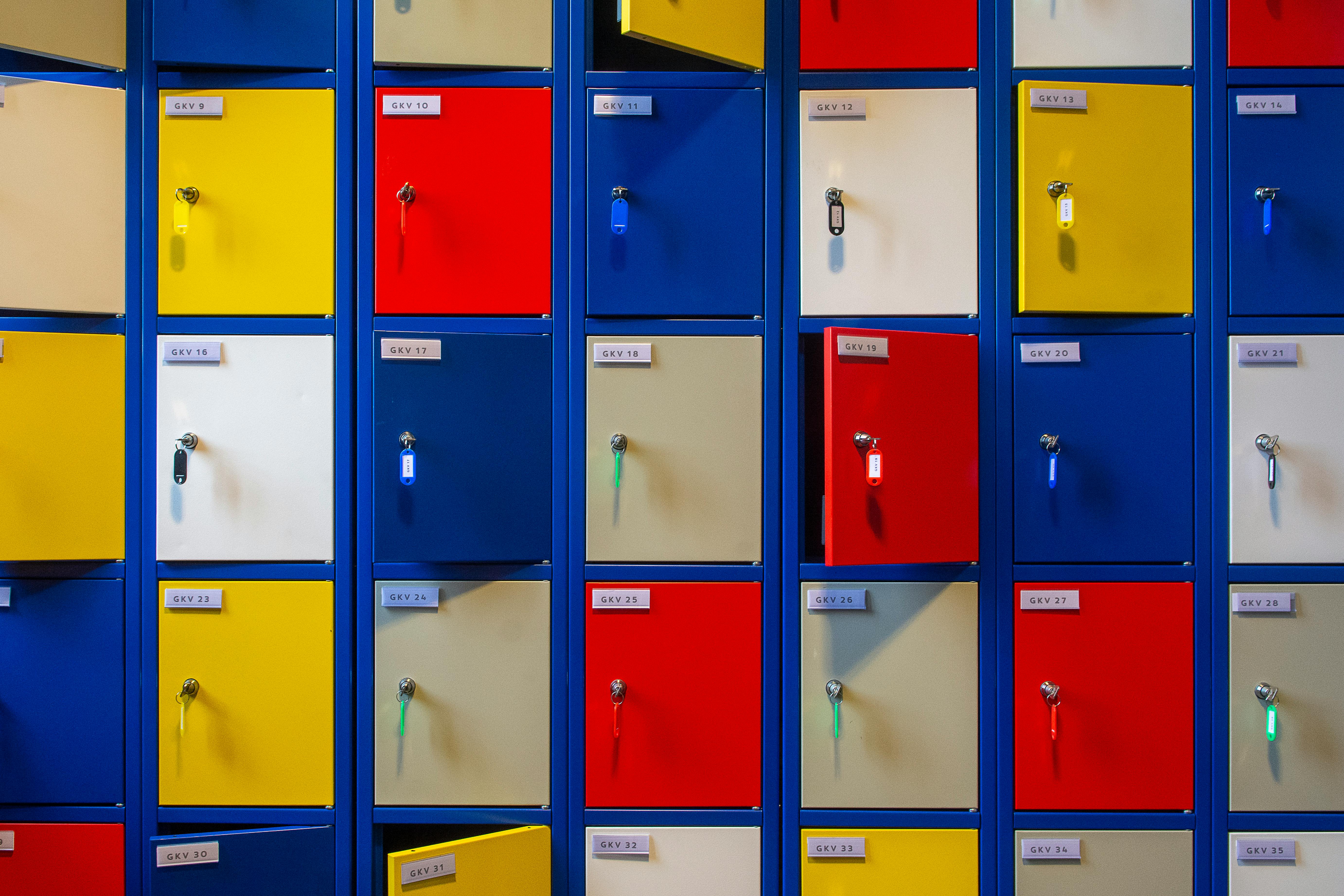 Vibrant multi-colored lockers with keys in an indoor setting.