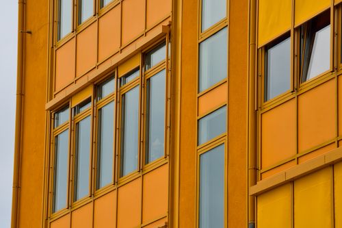 Free Vibrant close-up of a modern yellow building facade in Berlin, showcasing urban architecture. Stock Photo