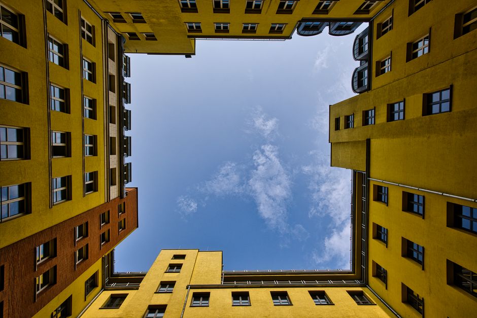 Dramatic perspective of vibrant Berlin courtyard against a clear sky.