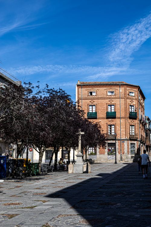 Free Charming view of a historic square in Ávila, Spain showcasing classic architecture under a bright blue sky. Stock Photo