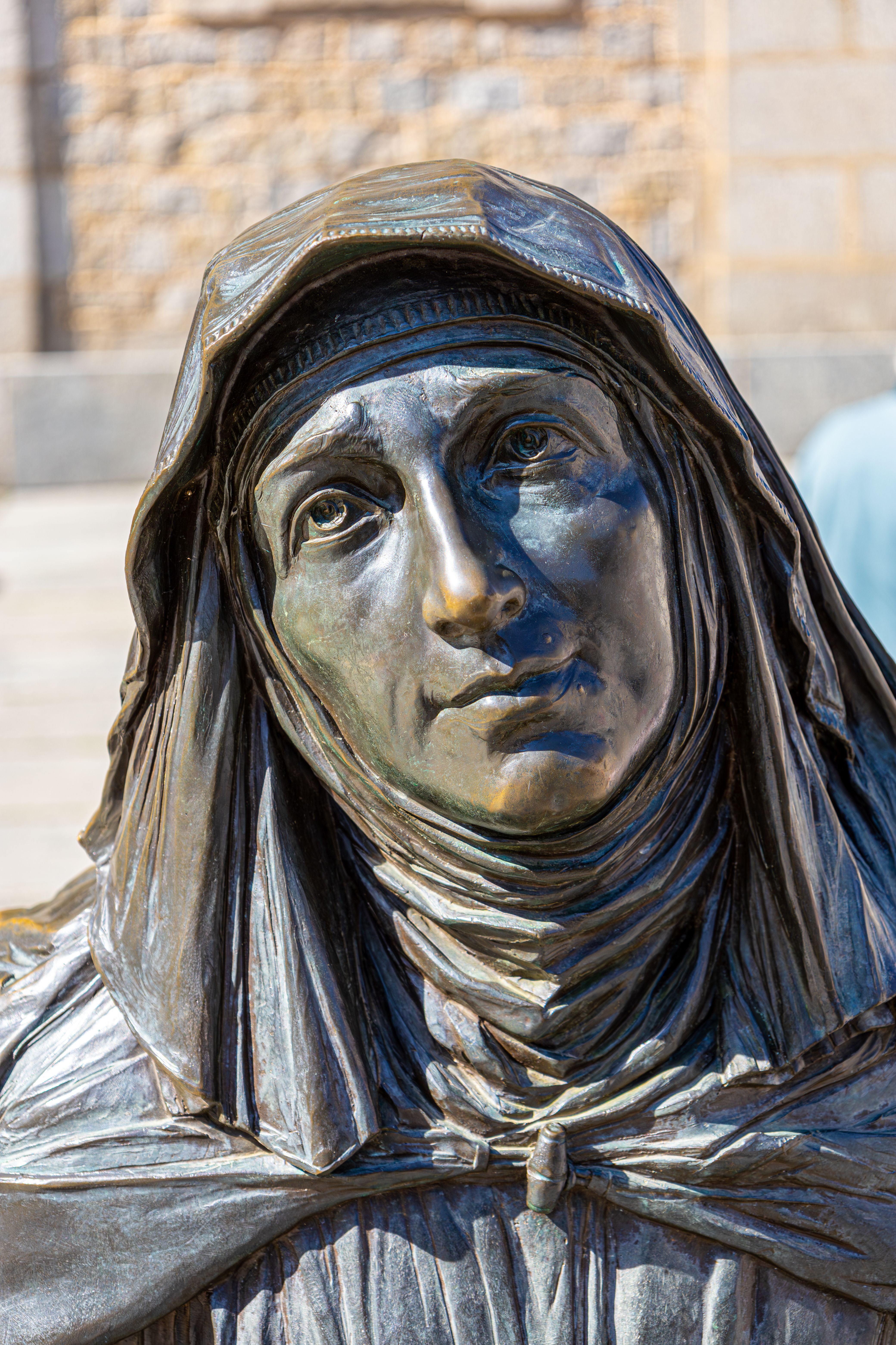 Close-up of a bronze statue portraying a historical figure in Ávila, Spain.