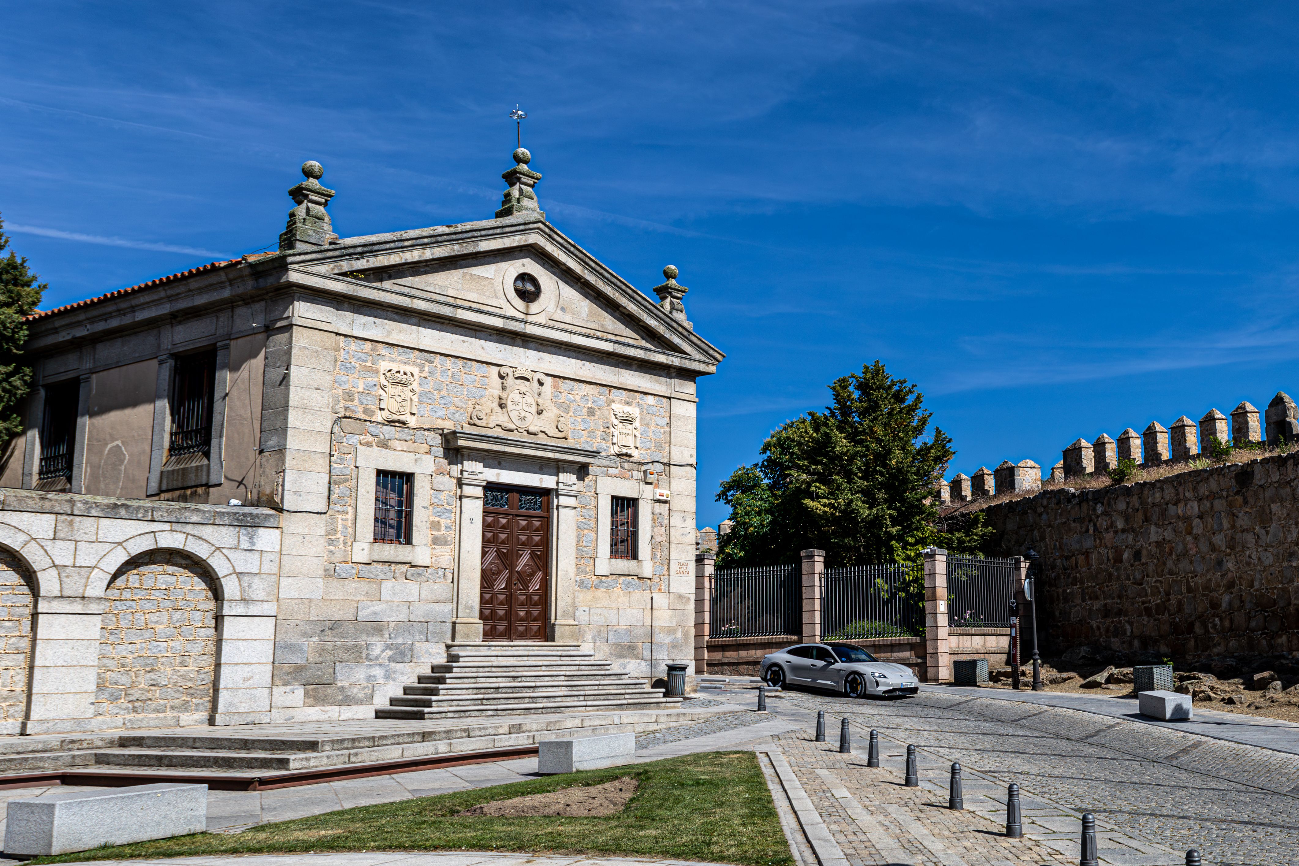 Stone building in Ávila, Spain, under clear blue skies.