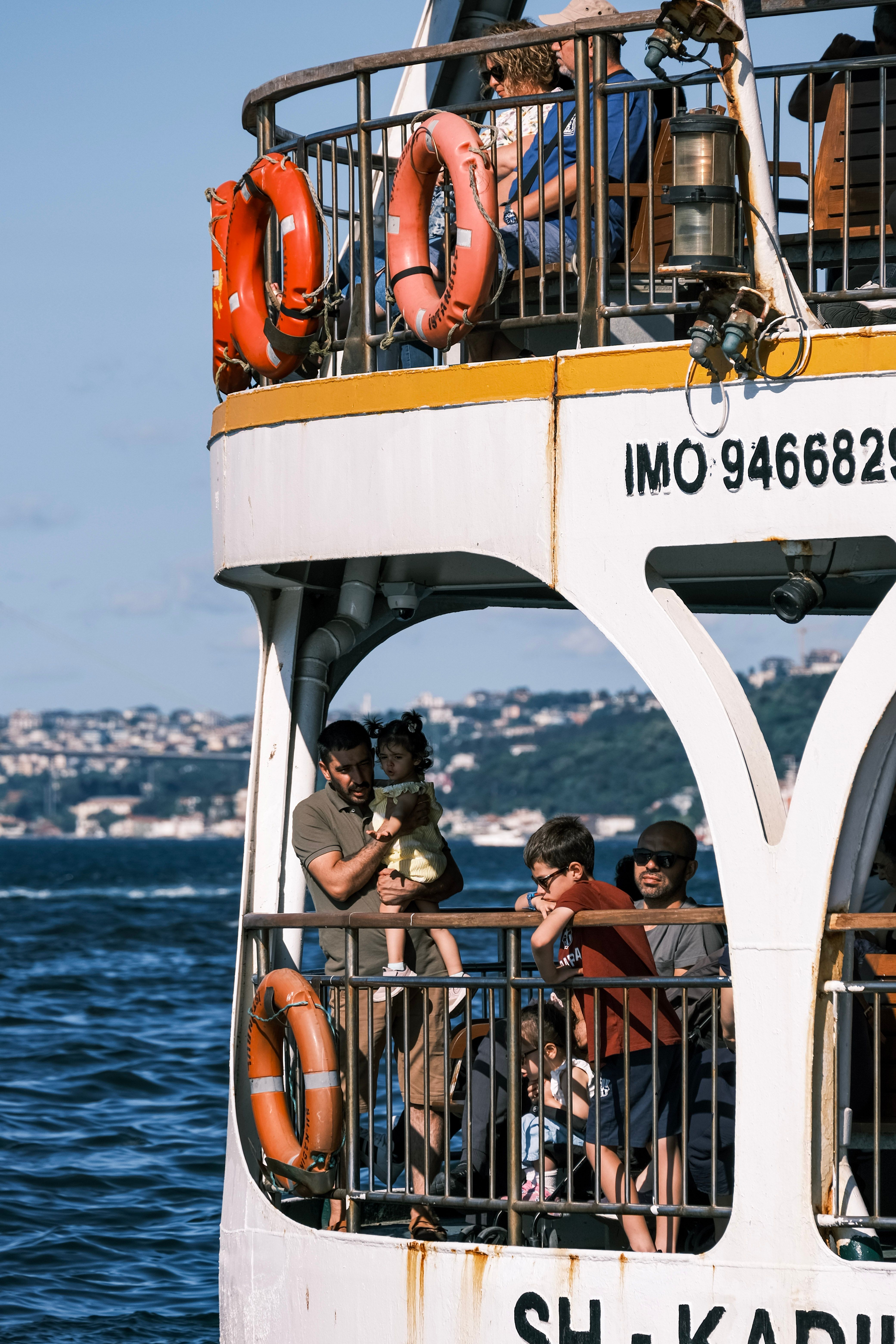 Family Enjoying Ferry Ride on Sunny Day · Free Stock Photo
