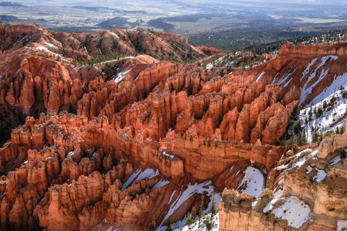 Free A stunning aerial view of Bryce Canyon's striking hoodoos with snow patches, showcasing natural beauty. Stock Photo