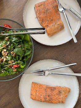 Healthy homemade dinner featuring grilled salmon and fresh walnut salad.