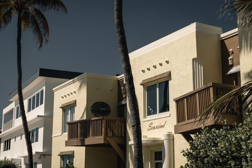 Free Charming seaside apartments under palm trees in Hollywood, Florida. Stock Photo