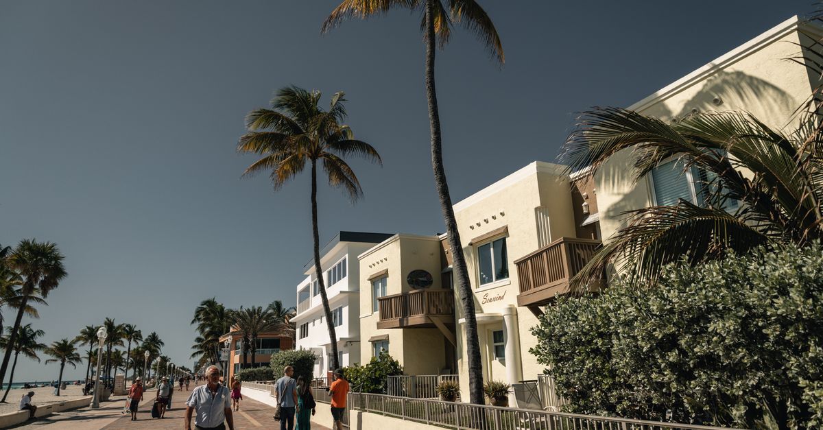 Stroll along the scenic Hollywood Beach boardwalk lined with palm trees and sunny skies.