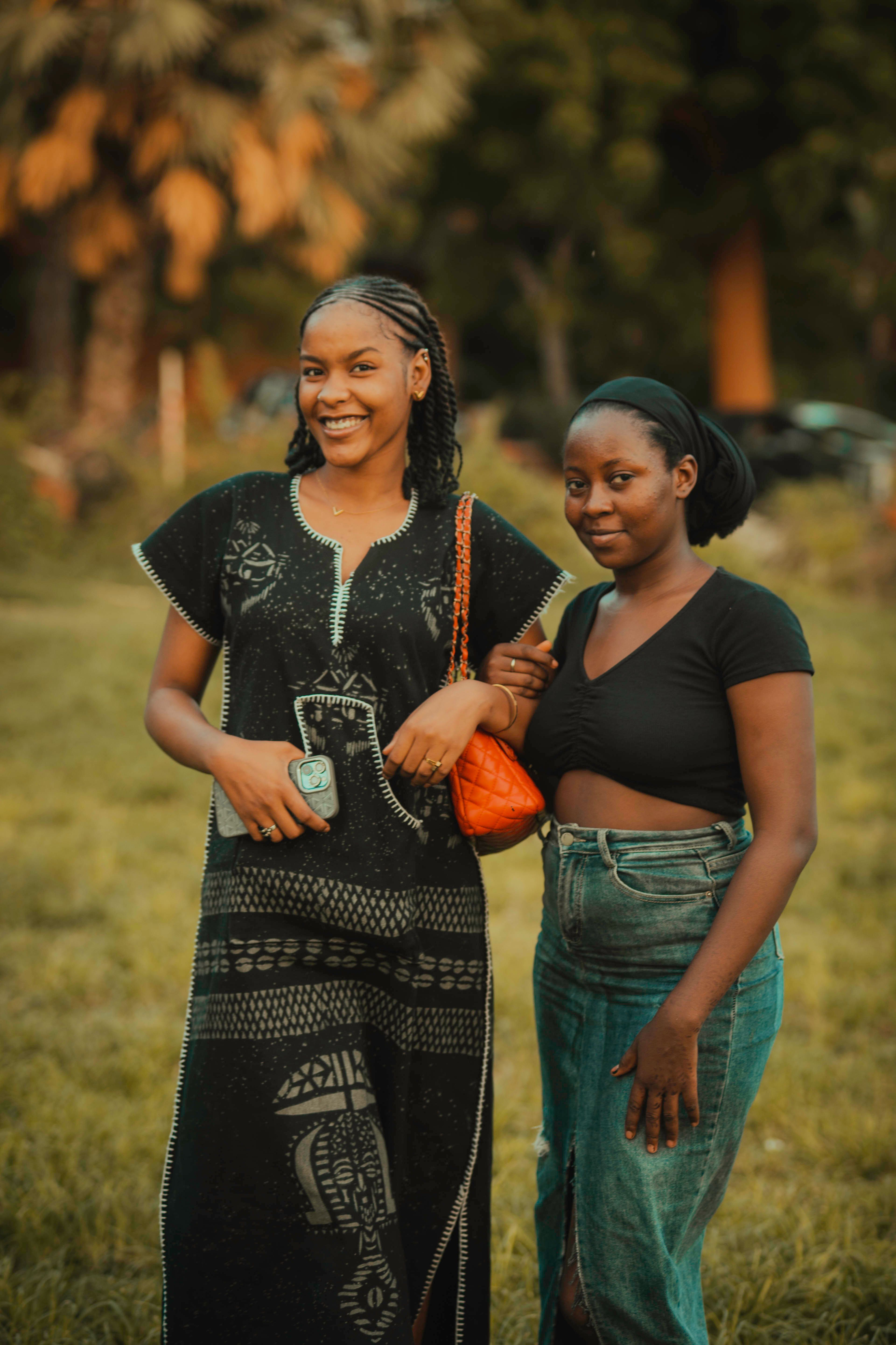 Two Women Smiling Outdoors in Casual Attire · Free Stock Photo