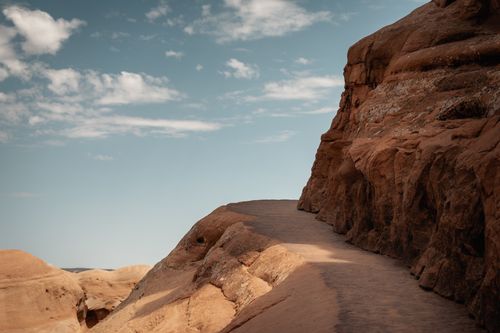 Free Explore a stunning desert pathway with red rock formations under a clear blue sky in Utah. Stock Photo