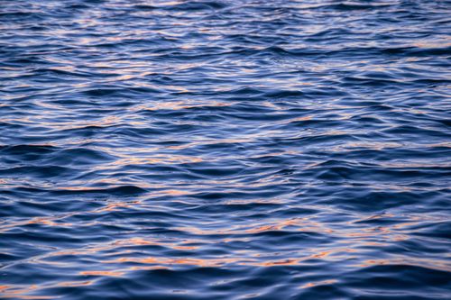 Free Serene water surface reflecting a golden sunset at The Entrance North, Australia. Stock Photo