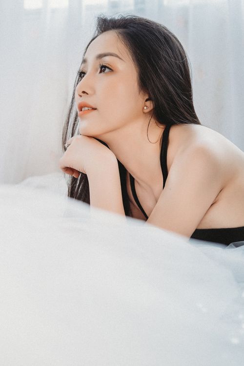 Free A serene portrait of a woman resting in soft lighting, exuding calm elegance. Stock Photo