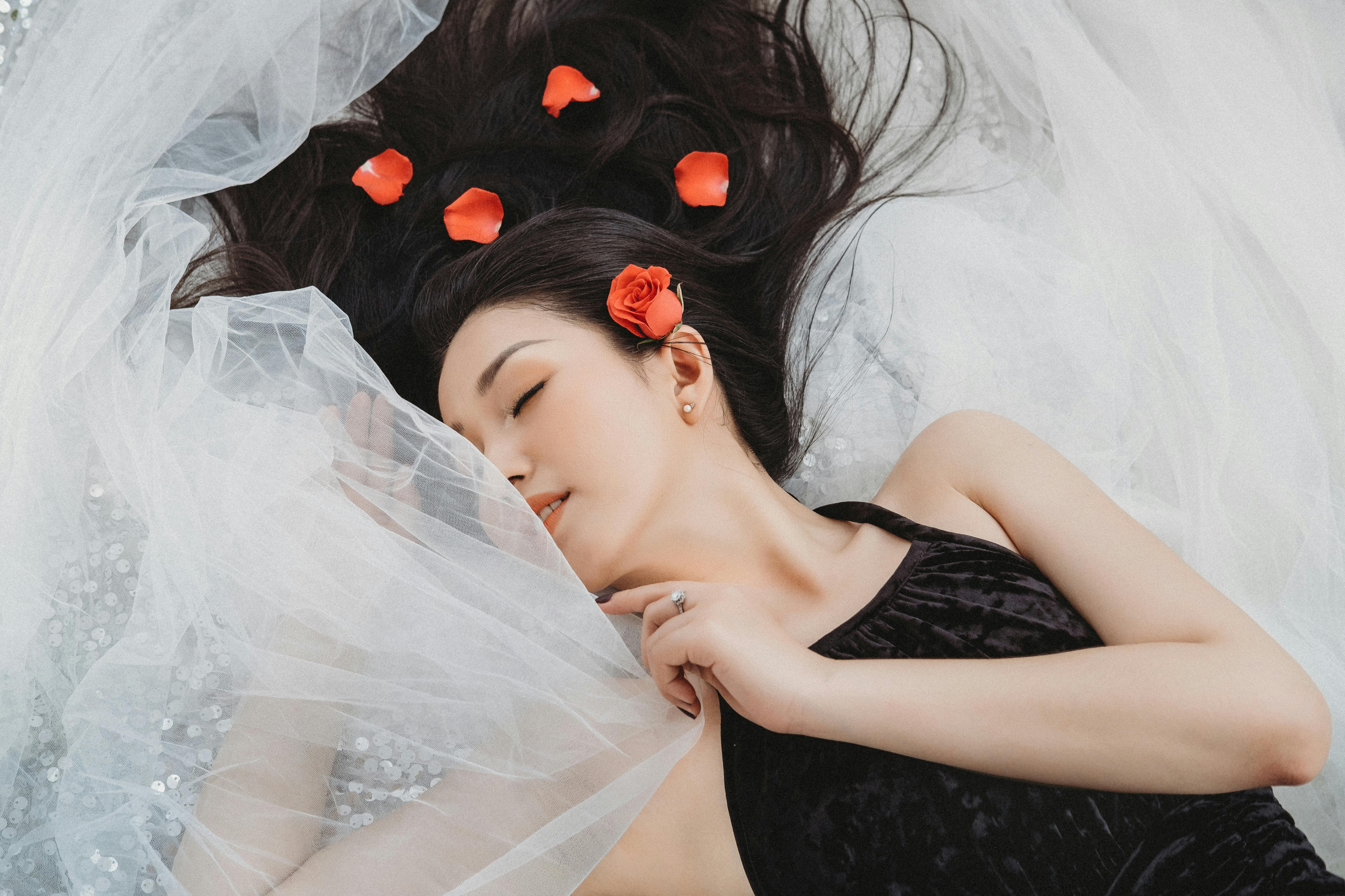 photo of woman laying on veil