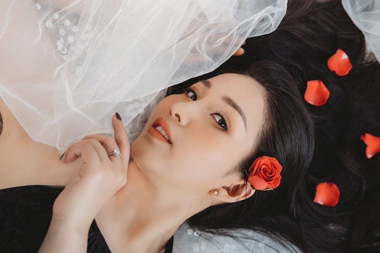 Romantic Asian Woman Lying On White Tulle Fabric