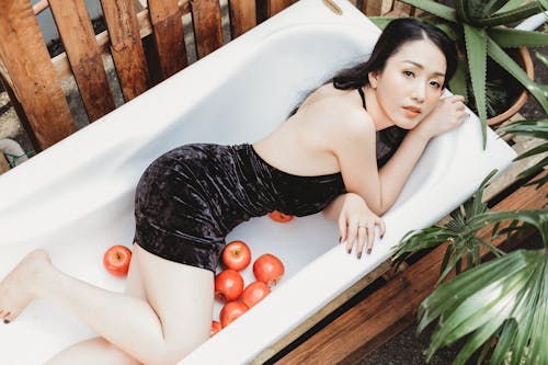 Free Photo Shoot of Woman on in Bathtub With Apples Stock Photo