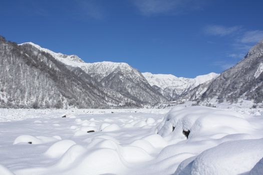 Breathtaking snowy mountain landscape under a vivid blue sky.
