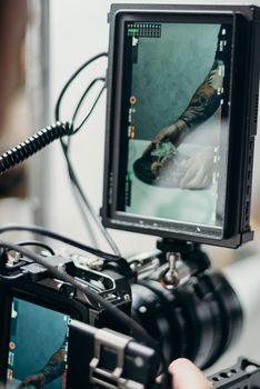 Behind-the-scenes view of a food photography session featuring a camera and monitor displaying the shot.
