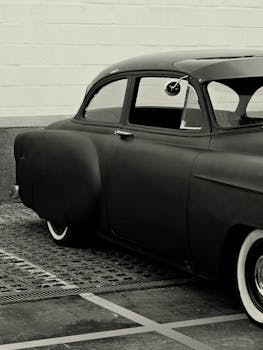 Classic vintage car in black and white, showcasing retro style.
