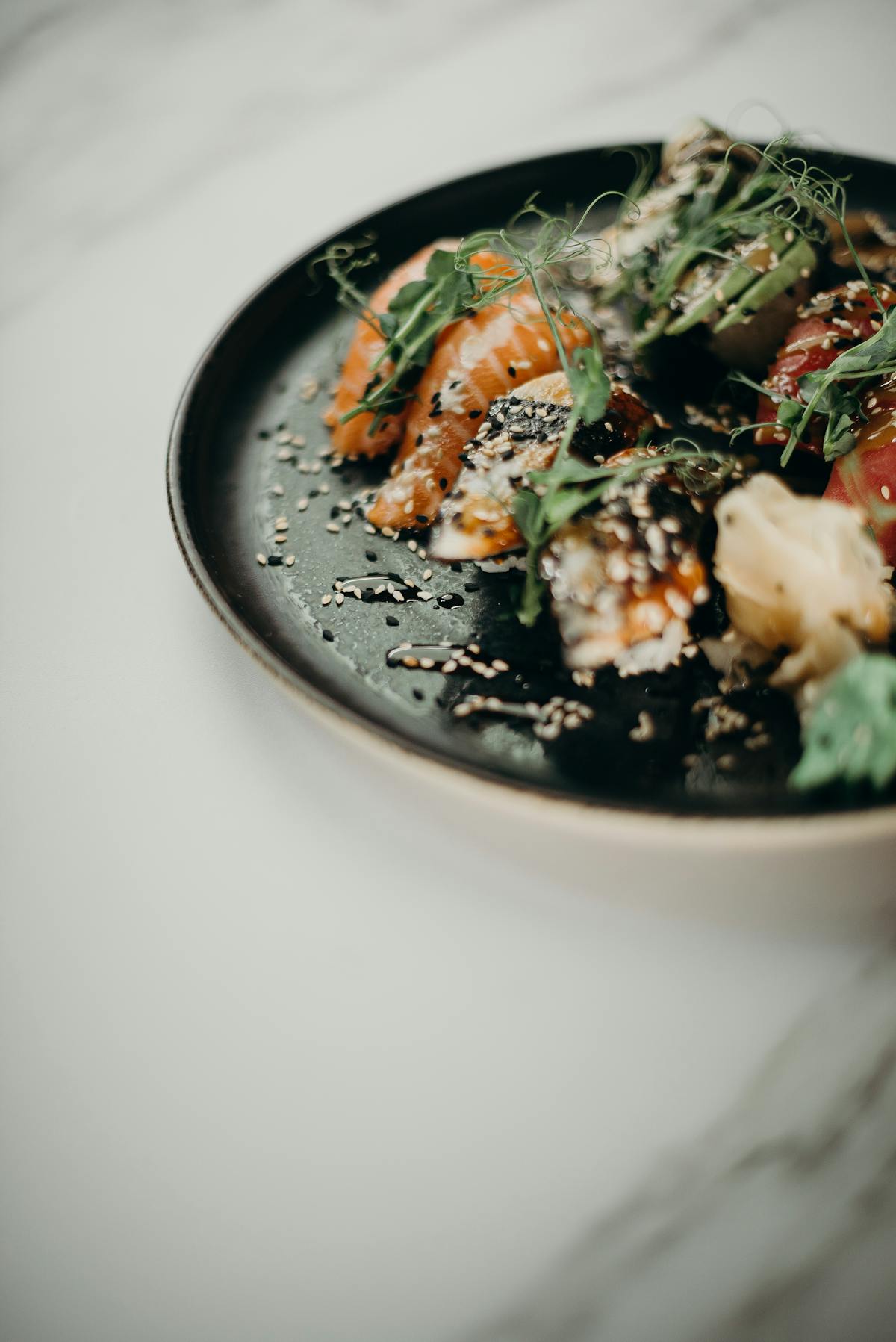 Close-up of a bowl being assembled with grains, vegetables, and protein