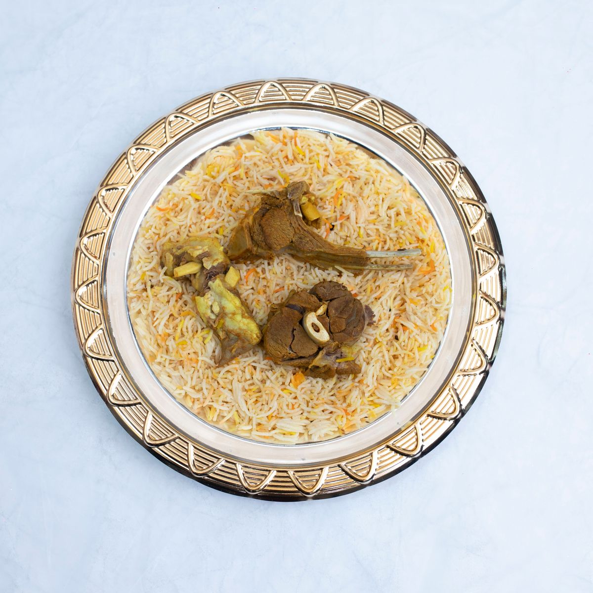 Aqiqah goat dish plated on a serving platter for a family gathering