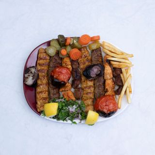 Mixed charcoal grill platter with kebabs and fries, photo by J KREATOR on Pexels