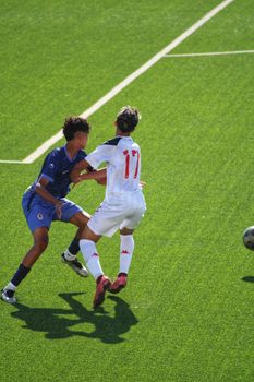 Two soccer players competing intensely on the field during a match.