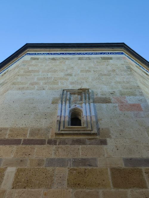Free Upward view of a textured stone wall against clear blue sky, architectural details. Stock Photo