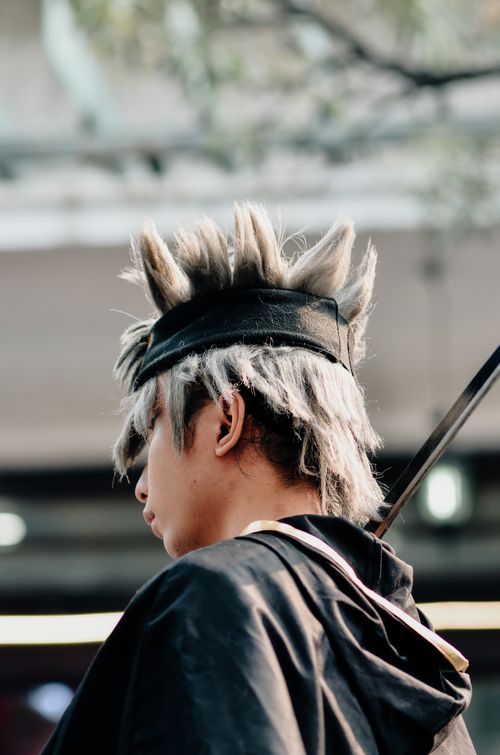 Free Anime cosplayer in character with spiky hair during outdoor event in Bandung, Indonesia. Stock Photo
