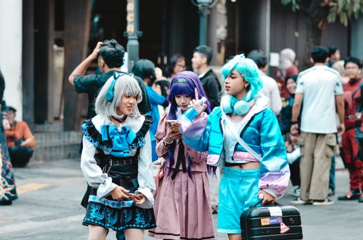 Colorful cosplay event with characters showcasing vibrant anime costumes in Bandung, Indonesia.