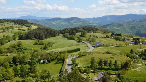 Free A vibrant landscape view of Barre-des-Cévennes, Occitanie, France, with lush greenery and rolling hills. Stock Photo