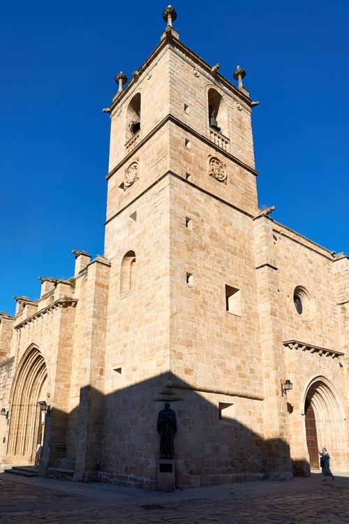 Free A stunning view of the historic church tower in Cáceres, Spain under a clear blue sky. Stock Photo