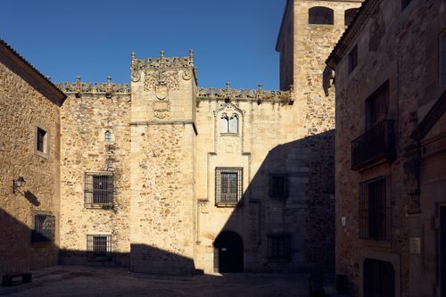 Free Sunlit stone building in a European courtyard, showcasing medieval architecture. Stock Photo