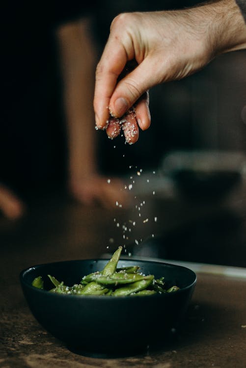 Free Person Seasoning Green Beans With Salt Stock Photo