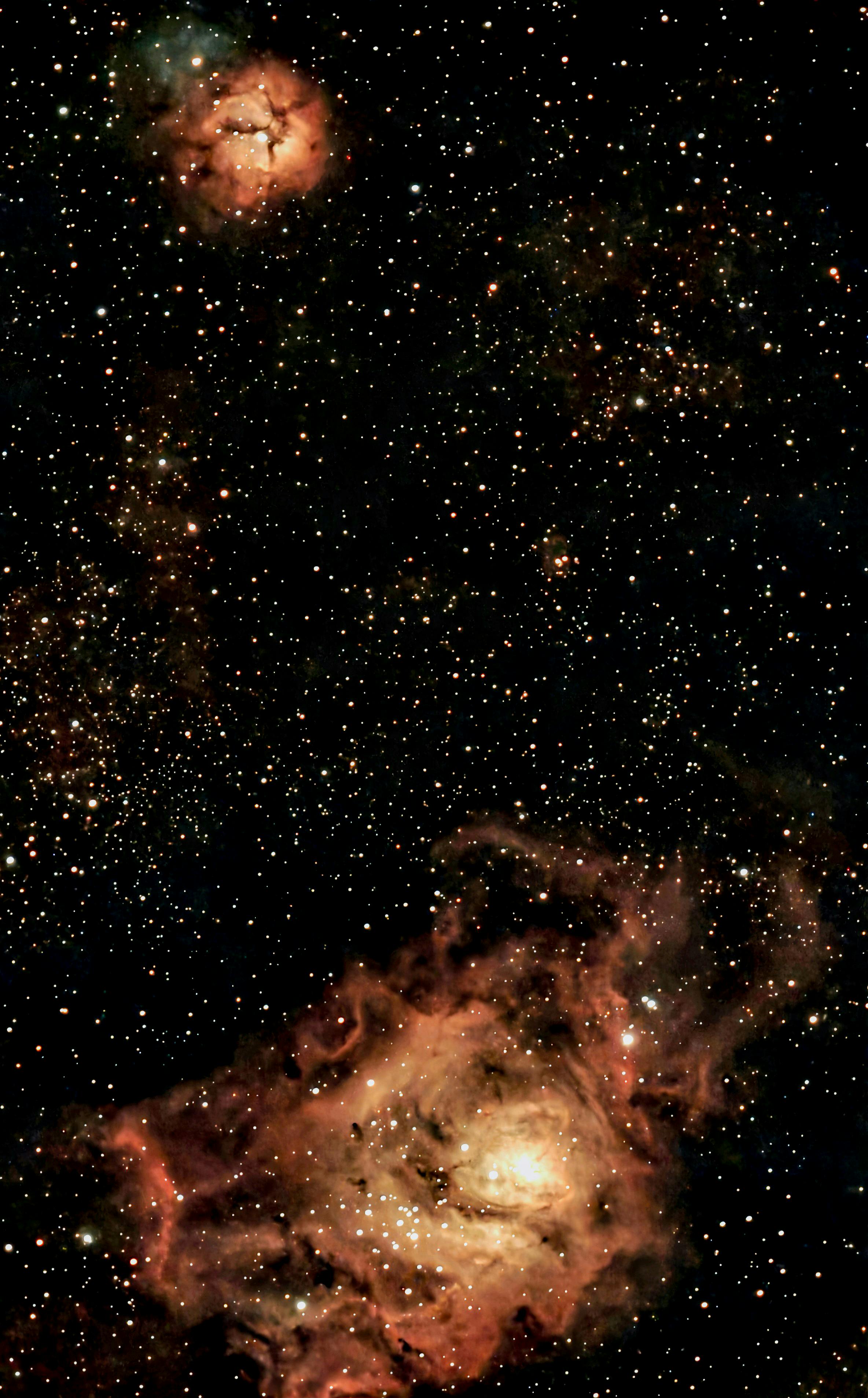 Spectacular starry sky featuring two radiant nebulae amidst a galaxy of stars.
