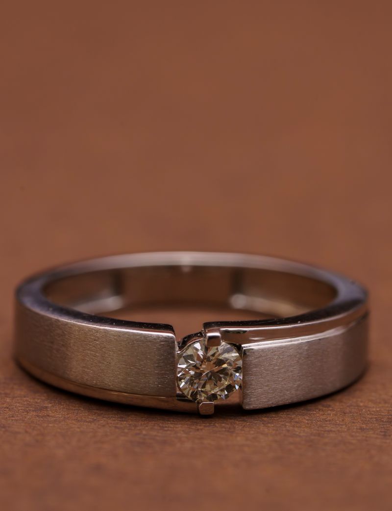 Close-up of a platinum ring featuring a solitaire diamond