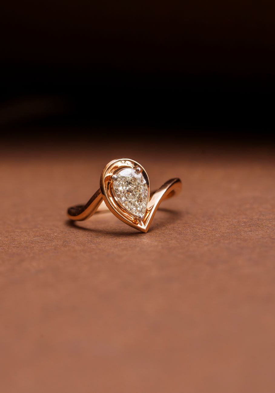 Gold diamond ring presented on black sculptural stone