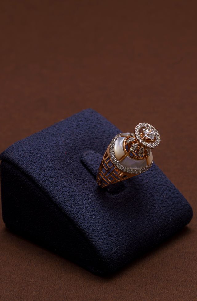 Diamond solitaire ring displayed on a velvet stand