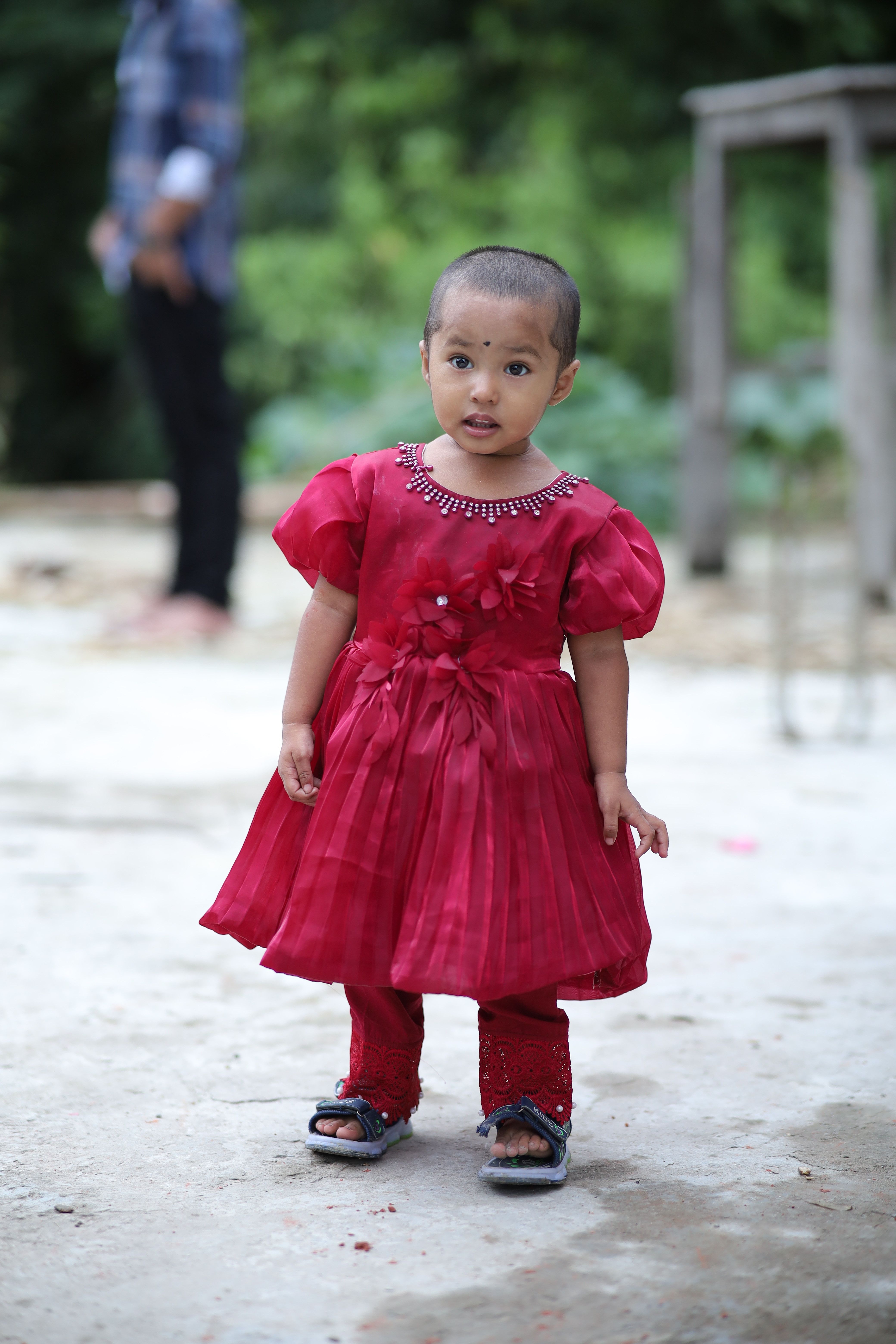 Toddler in Red Dress Outdoors Cutely Posing · Free Stock Photo