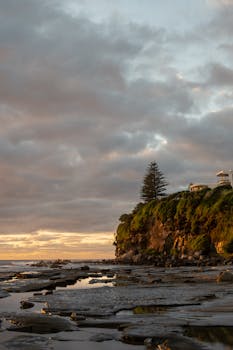 Serene sunrise view over cliffs and ocean at Sunshine Coast, Australia.