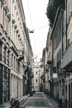 Explore Milan's charming architecture in this scenic street view, showcasing classic Italian design.