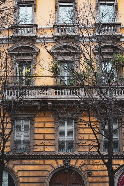 Free Elegant facade of historic Italian building with ornate designs in Milan, Italy. Stock Photo