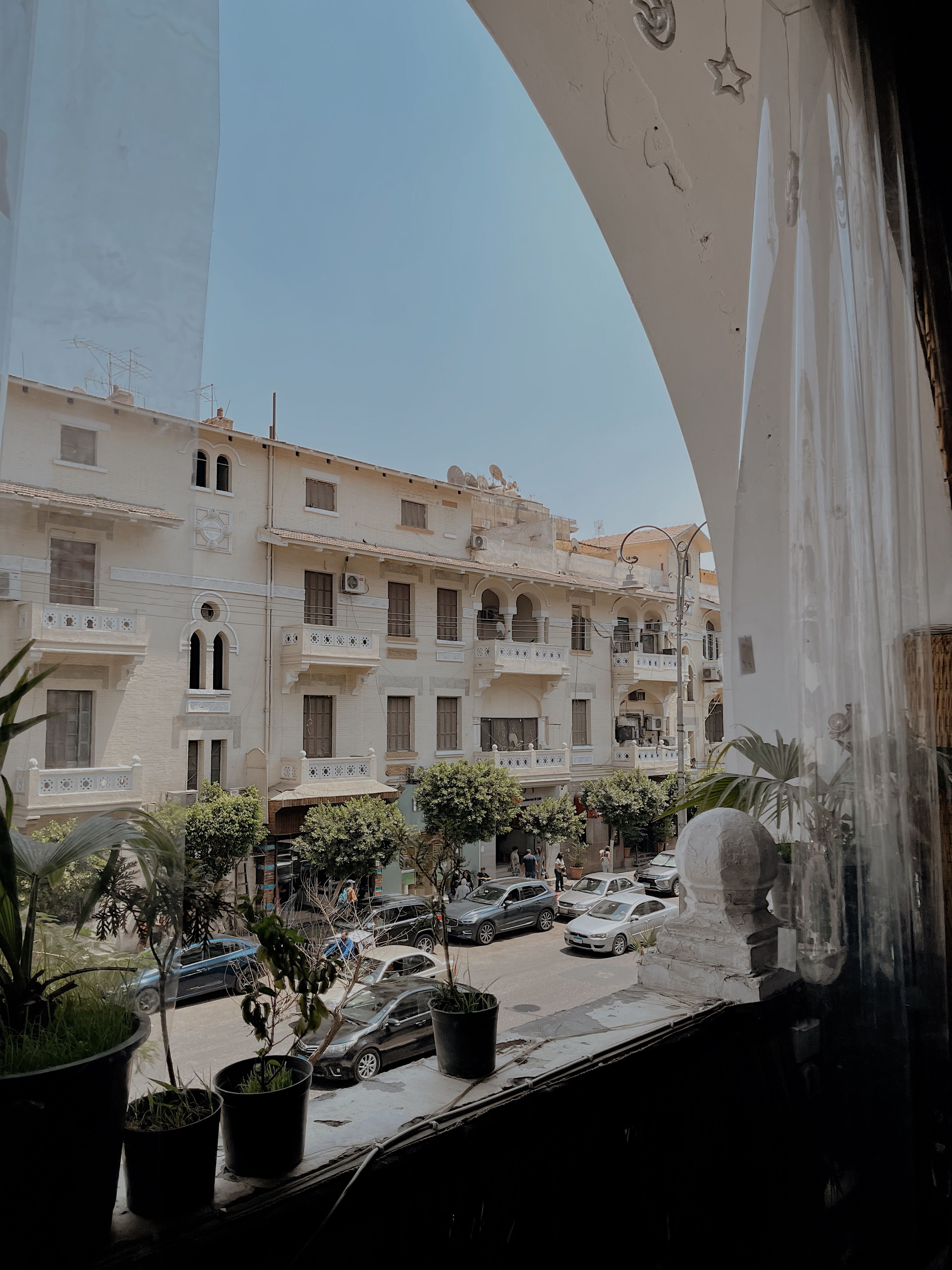 Urban Street View Through Arched Window · Free Stock Photo