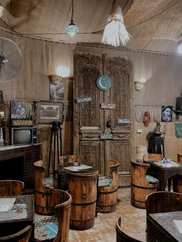 Vintage style Middle Eastern café with wooden furniture and cultural decor.