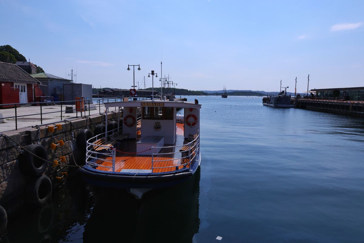 A boat docked at Oslo harbour with clear blue sky