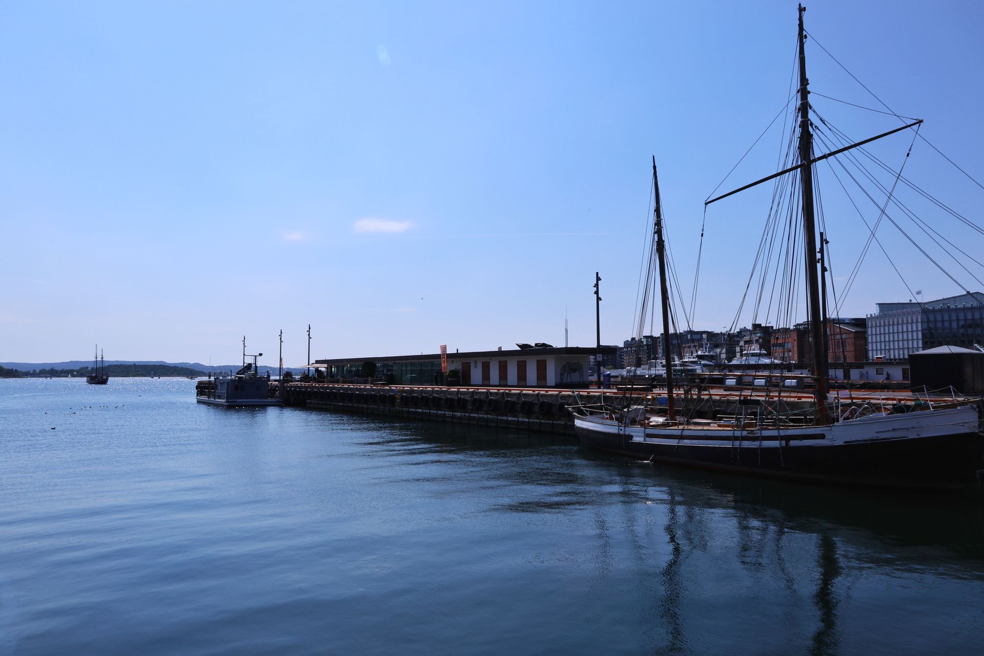 Wide view of a bronze monument on Oslo's harbour front
