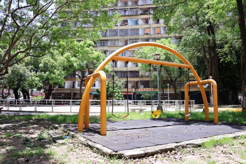 Free Vibrant playground in Kaohsiung, Taiwan, showcasing colorful swings and lush greenery on a sunny day. Stock Photo