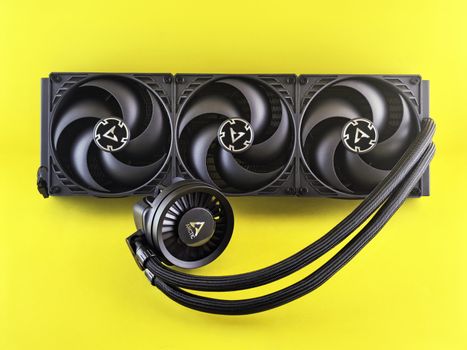 Triple fan CPU cooler with colorful background, efficient for gaming PCs.