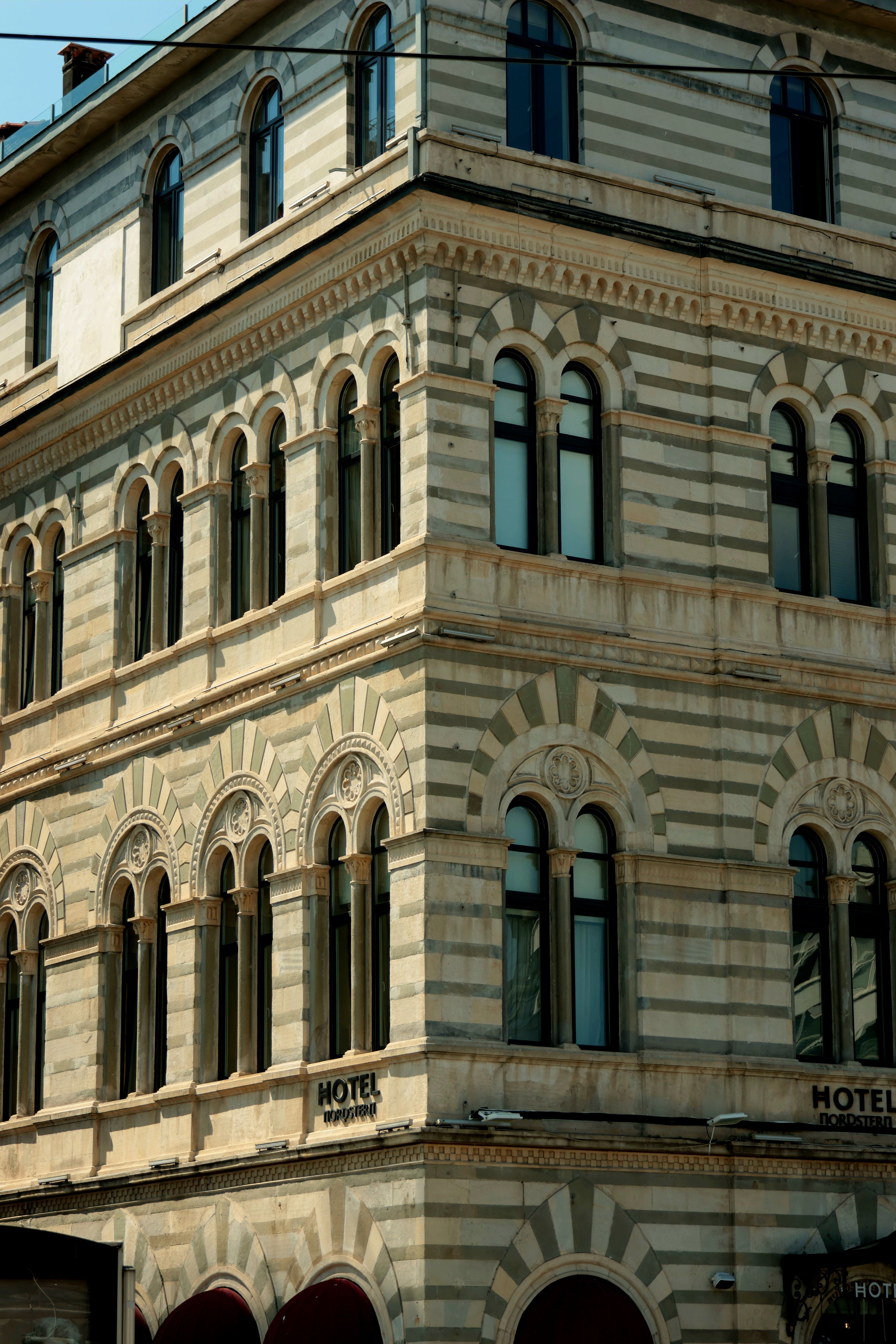 Historic Hotel Architecture with Arched Windows · Free Stock Photo