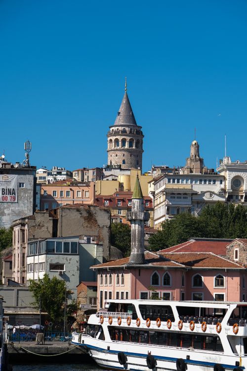 Free A scenic view of Istanbul's iconic Galata Tower with boats on the Bosphorus under a clear blue sky. Stock Photo