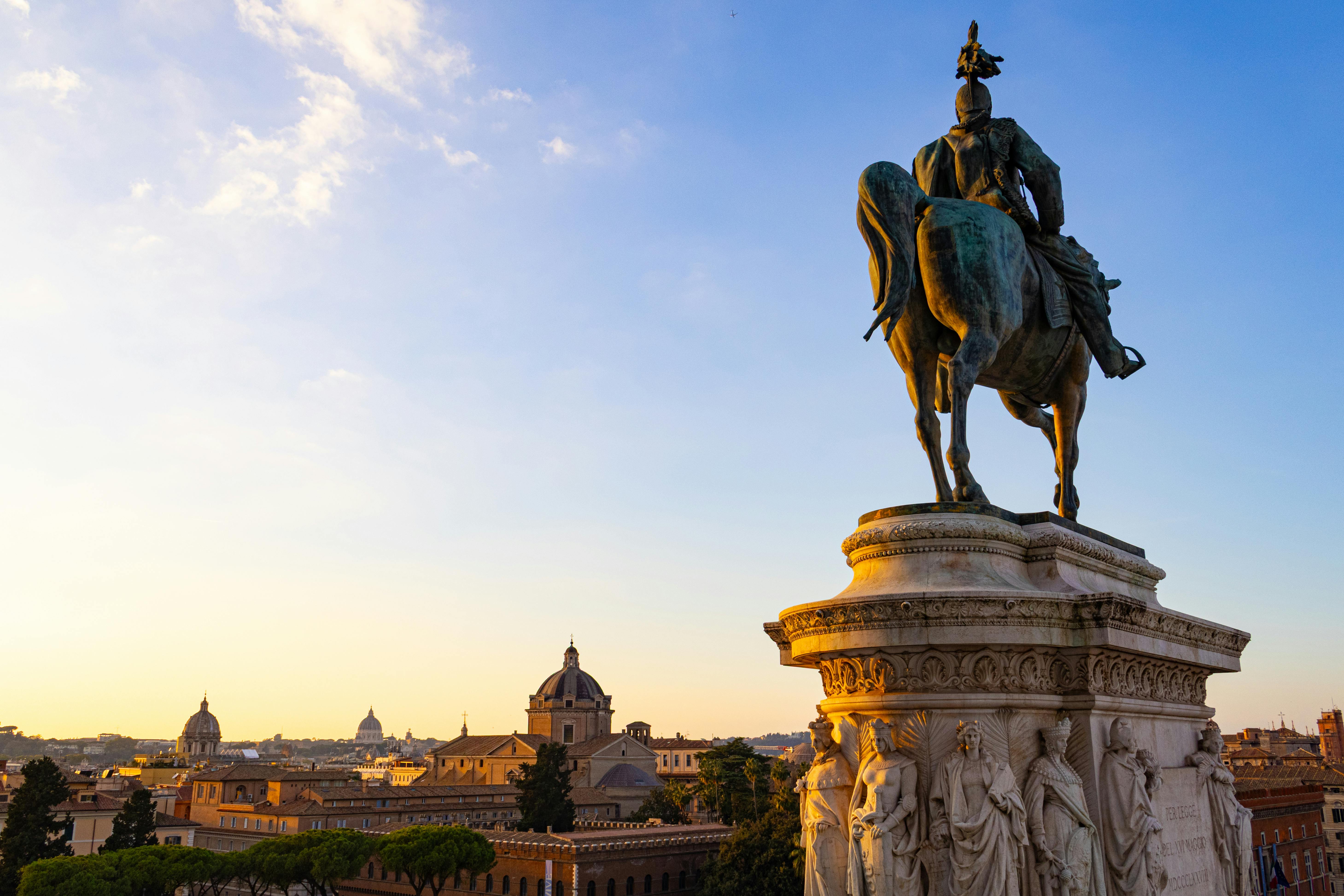 Equestrian statue overlooking the beautiful skyline of Rome, Italy, at sunset.