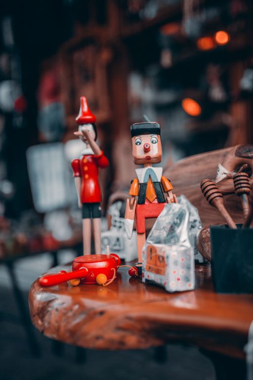 Free Charming display of wooden toys and Pinocchio figurines on a table indoors. Stock Photo
